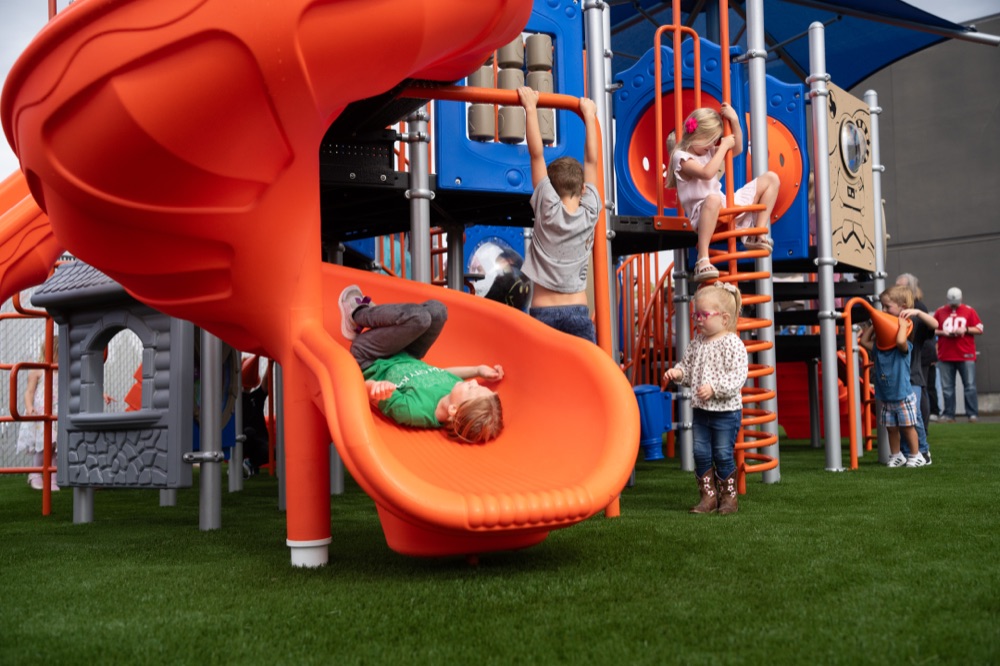 Children climbing and sliding on the Sun City CDC playground